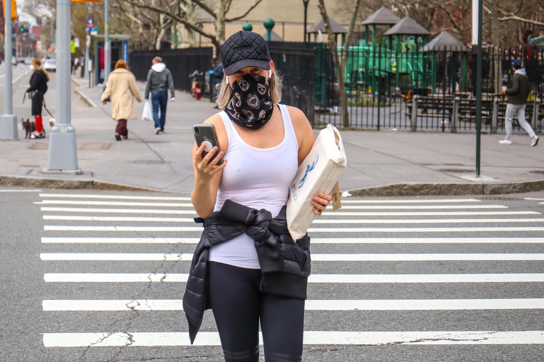 A woman wearing a bandana as a mask
